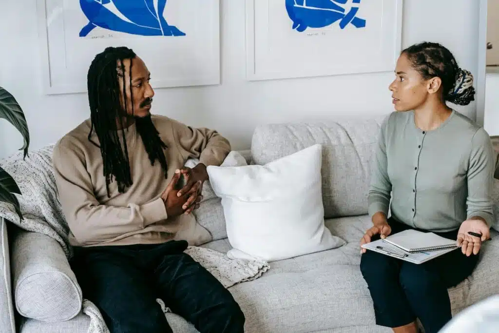 Black man listening to female psychologist advice
